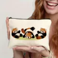 Close-up detail of a white canvas zipper pouch featuring cute red panda cartoon prints. - Style 6