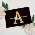 Custom black cosmetic bag featuring a chic gold letter and personalized white name design. - Letter A