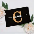 Customizable black canvas cosmetic pouch with floral decoration and personalized letter name. - Letter C