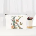 Floral letter K cosmetic bag, elegant canvas makeup pouch for bridal gifts and daily travel storage. - Letter K