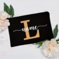 Custom black canvas cosmetic pouch featuring initial letter and floral background detail. - Letter L