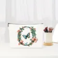 Floral letter O makeup pouch detail, canvas cosmetic bag with butterfly, elegant gift. - Letter O