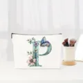 Watercolor letter P floral makeup bag detail showing elegant butterfly and floral monogram print. - Letter P