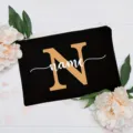 Customizable black canvas makeup pouch with elegant floral decor and alphabet print for women. - Letter N
