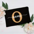 Close-up detail of custom letter black canvas pouch decorated with floral background. - Letter O