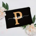 Custom letter cosmetic bag with floral decor, chic black canvas pouch for daily use. - Letter P