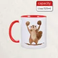 Detailed view of the ceramic mug featuring a cute squirrel illustration holding nuts closeup. - 06-Red Handle Squirrel