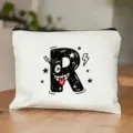 Witte canvas cosmetische tas met een schattige cartoon letter R print en zwarte rits. - Letter R