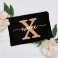 Custom initial black cosmetic bag with floral design, personalized letter zipper pouch. - Letter X