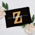 Customizable black canvas cosmetic bag with letter Z and forest floral background detail view. - Letter Z