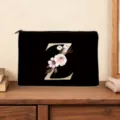 Elegant black cosmetic bag featuring a golden letter Z and floral design for women daily use. - Letter Z