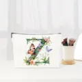 Close-up detail shot of alphabet Z canvas cosmetic makeup bag with floral butterfly print. - Letter Z