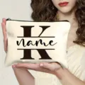 Detail view of customized canvas makeup bag with letter K print and convenient black zipper. - Letter K