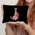Detailed view of the black canvas cosmetic pouch featuring a rose gold letter J and floral print. - Letter J Style(10) / Black