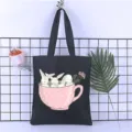 Detail view of a black canvas tote bag featuring a cute rabbit teacup print, perfect for daily use. - Style 12 / 35*40cm