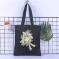 Detail view of black canvas tote bag with cute cartoon rabbit print casual shoulder bag - Style 3 / 35*40cm