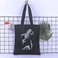 Detailed view of the black canvas tote bag featuring a unique artistic rabbit print design. - Style 1 / 35*40cm