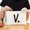 Canvas cosmetic bag with zipper closure, featuring minimalist letter print for daily makeup storage. - Style V