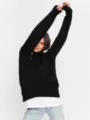 Detailed view of the black oversized turtleneck sweater, soft knit texture and cozy fit. - S / Tops / Black
