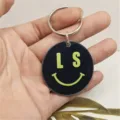 Creative acrylic round keychain with smiley face print, stylish bag charm and accessory. - Gray