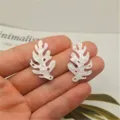 Detailed view of white acrylic leaf seashell charms, perfect for DIY hair accessories and crafts. - Left Side (20x32mm) / White