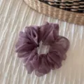 Detail shot of purple sheer organza hair scrunchie showing fine fabric texture and elasticity. - Dusty Pink