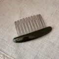Close up view of elegant acetate hair insert comb, showing fine teeth and smooth glossy finish. - Green
