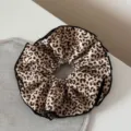 Vista dettagliata dell'elastico per capelli con stampa leopardata e bordo nero chic. - Leopardo Chiaro alla Moda - Elastico