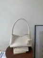 Detailed view of the elegant white woven shoulder bag, chic intrecciato hobo bag for women. - White