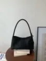Black woven leather shoulder bag chic minimalist underarm baguette bag for daily commute. - Black