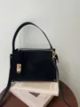Elegant black retro box shoulder bag with chic gold hardware and top handle for women daily commute. - Black