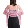 Elegant pink lace evening shawl detail, floral hollow pattern with delicate fringe trim. - Dusky Pink