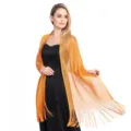 Detailed view of shimmering metallic fringe evening shawl, elegant party wrap accessory. - Orange