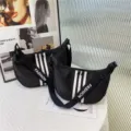 Black oxford cloth crossbody bag for women, large capacity casual dumpling handbag with stylish stripes. - Black