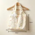 Detailed view of canvas floral embroidered tote bag with lace bow, dimensions 38x32x6cm. - Floral Embroidered Tote Bag Without Pendant / Beige