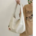 Minimalist white shoulder bag for women, large capacity hobo bag with wide strap and pocket. - Off White