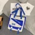Canvas crossbody bag for women, large capacity waterproof student shoulder bag, stylish casual tote. - Blue