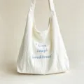 White canvas shoulder bag with blue letter embroidery, casual tote bag for women daily commute. - Off White