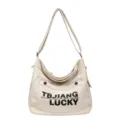 Casual canvas shoulder bag for women, large capacity crossbody tote bag with stylish letter print. - White