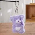 Detailed close-up view of the purple plush bear keychain featuring a white heart belly and metal ring. - Hello Bear Purple (Keychain)
