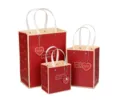 Red paper gift bags set with white ribbon handles and heart tags, assorted sizes. - 14x9x15cm / Red