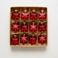 Red star Christmas tree hanging ornaments set, 12 pieces in brown box with size details. - Star Ornaments (12 Pieces/Boxed) / 16.5x15x2cm / Red