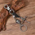 Retro punk metal skull keychain with leather wrap, dagger cross and dice pendant for car waist. - Black Leather