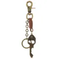 Porte-clés en métal bronze vintage avec lanière en cuir et pendentif crâne de style punk. - Marron