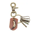 Close-up detail of antique bronze wolf tooth keychain with leather tag and rotating clasp. - Long Leather Piece Pendant Style / Coffee Leather