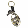 Llavero vintage de bronce con hoja de bellota y correa de cuero trenzado negro. - Estilo C