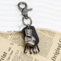 Detailed view of the vintage metal boxing glove keychain with leather backing and clasp. - Gloves