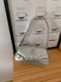 Silver metallic shoulder bag detail showing glossy PU leather finish and stylish metal buckles. - Silver