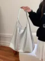 Silver metallic slouchy shoulder bag detail showing soft PU leather texture and large capacity. - Silver