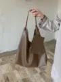 Close-up detail of stylish brown tote shoulder bag with pouch, casual large capacity design. - Mud Brown
